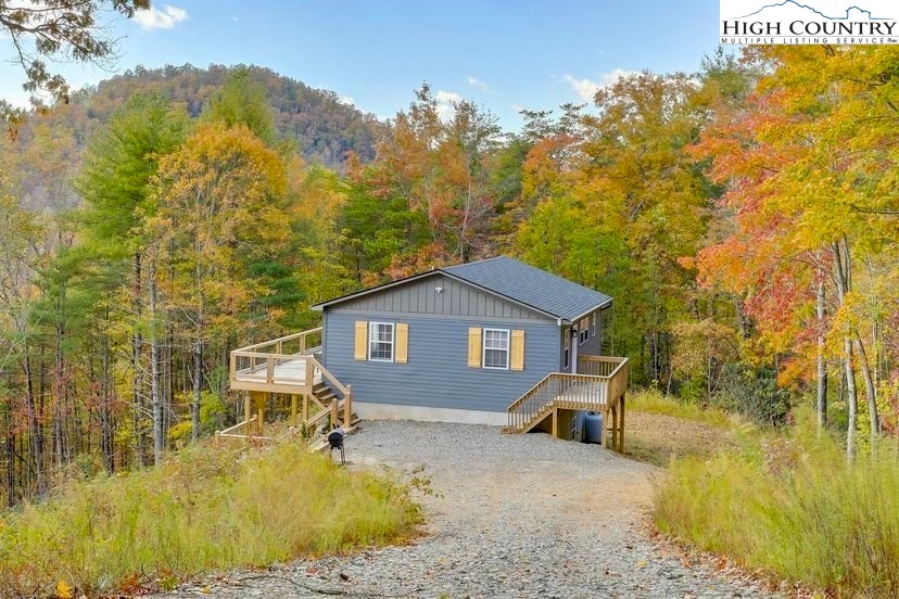 482 Bear Run Road Lenoir, NC 28645 - Photo 33 of 44 a front view of a house with a yard tree and wooden fence