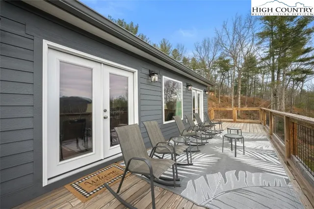 a view of balcony with furniture and large window