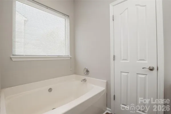 a bathroom with a tub and a window