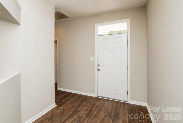 a view of an empty room and wooden floor