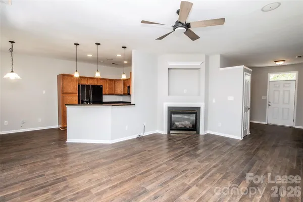 a view of a kitchen with a fireplace and wooden floor