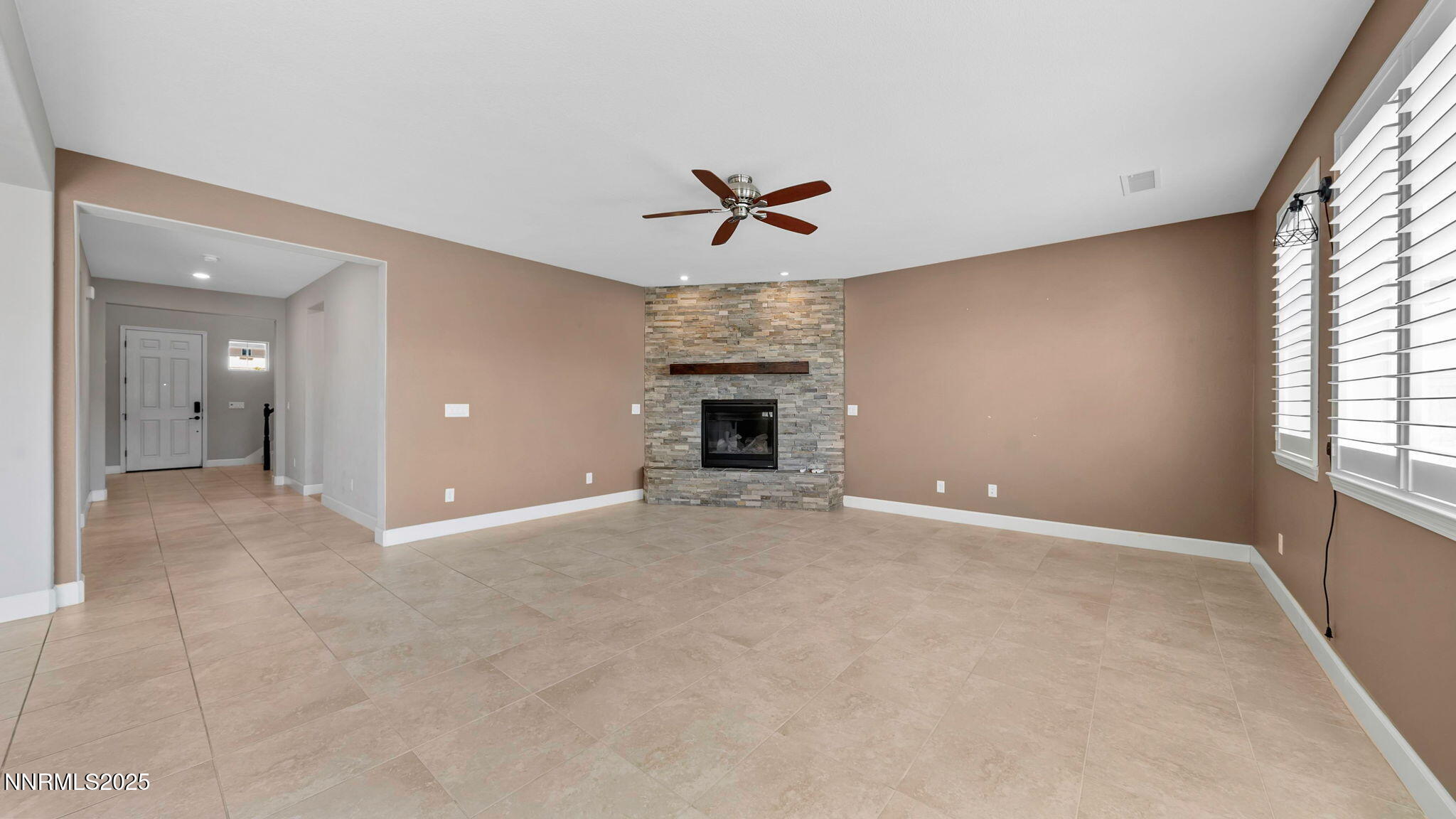 10455 Mott Court Reno, NV 89521 - Photo 15 of 41 an empty room with fireplace and windows
