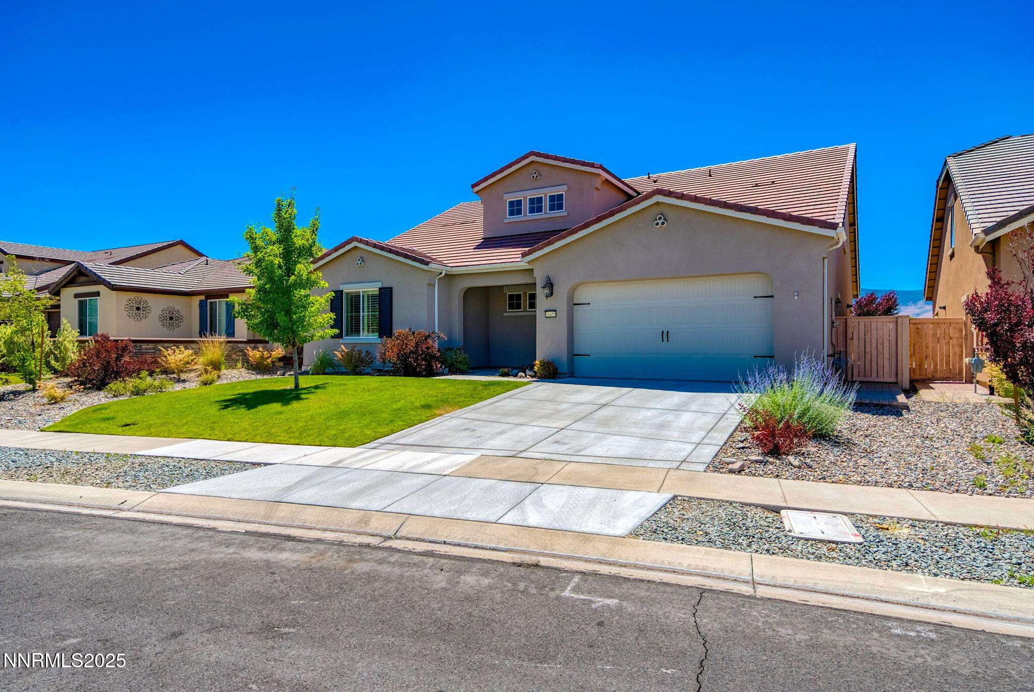 10455 Mott Court Reno, NV 89521 - Photo 3 of 41 a front view of house with garage and yard