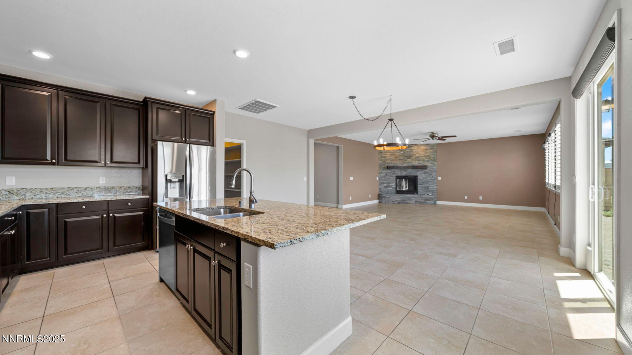 10455 Mott Court Reno, NV 89521 - Photo 8 of 41 a kitchen with kitchen island granite countertop a stove sink and cabinets