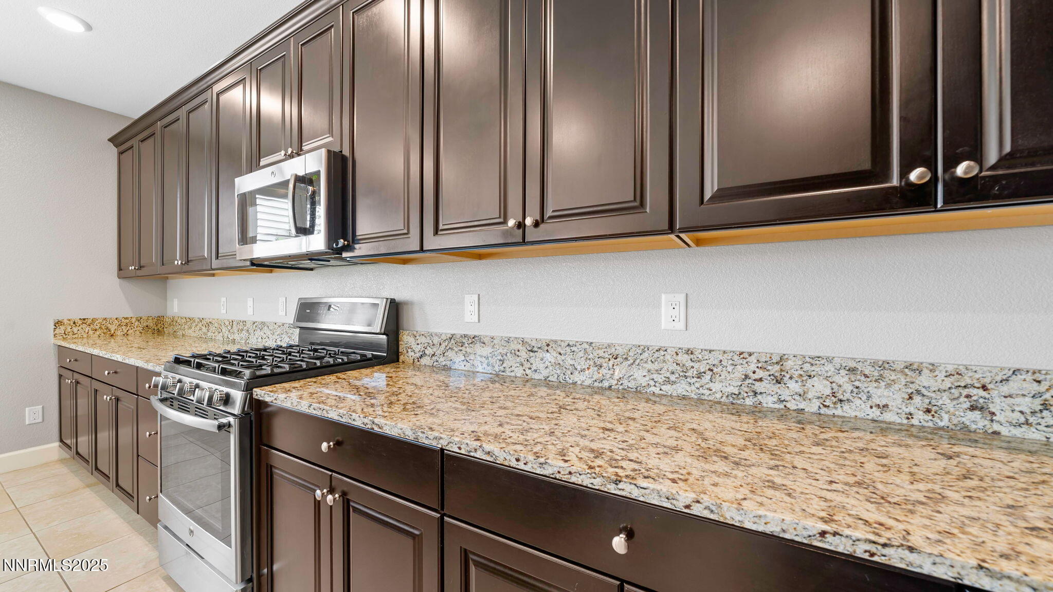10455 Mott Court Reno, NV 89521 - Photo 10 of 41 a kitchen with granite countertop cabinets stainless steel appliances and a sink