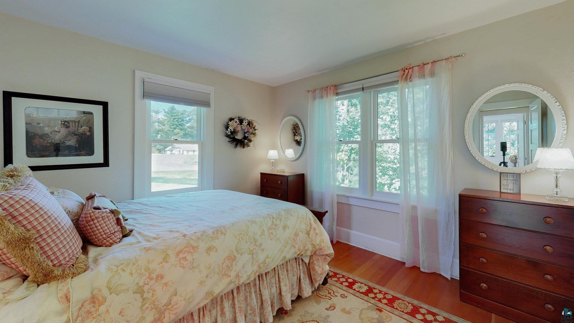 N1211 East Side Road Birchwood, WI 54817 - Photo 65 of 70 Bedroom featuring multiple windows and light wood finished floors