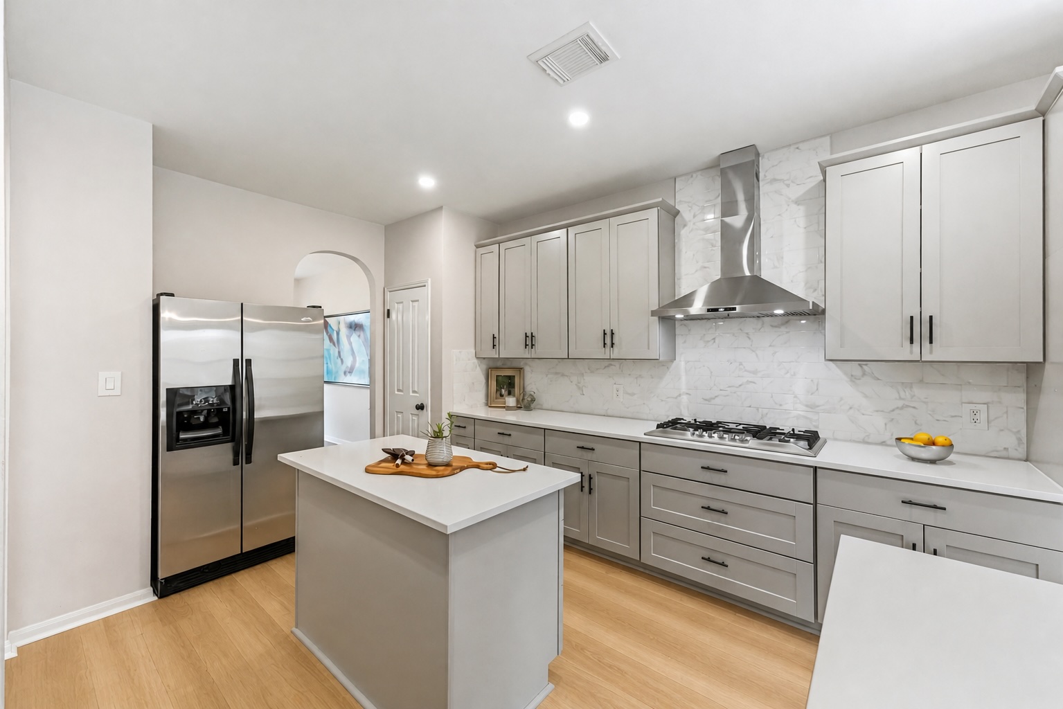 a kitchen with stainless steel appliances granite countertop a refrigerator stove top oven and sink