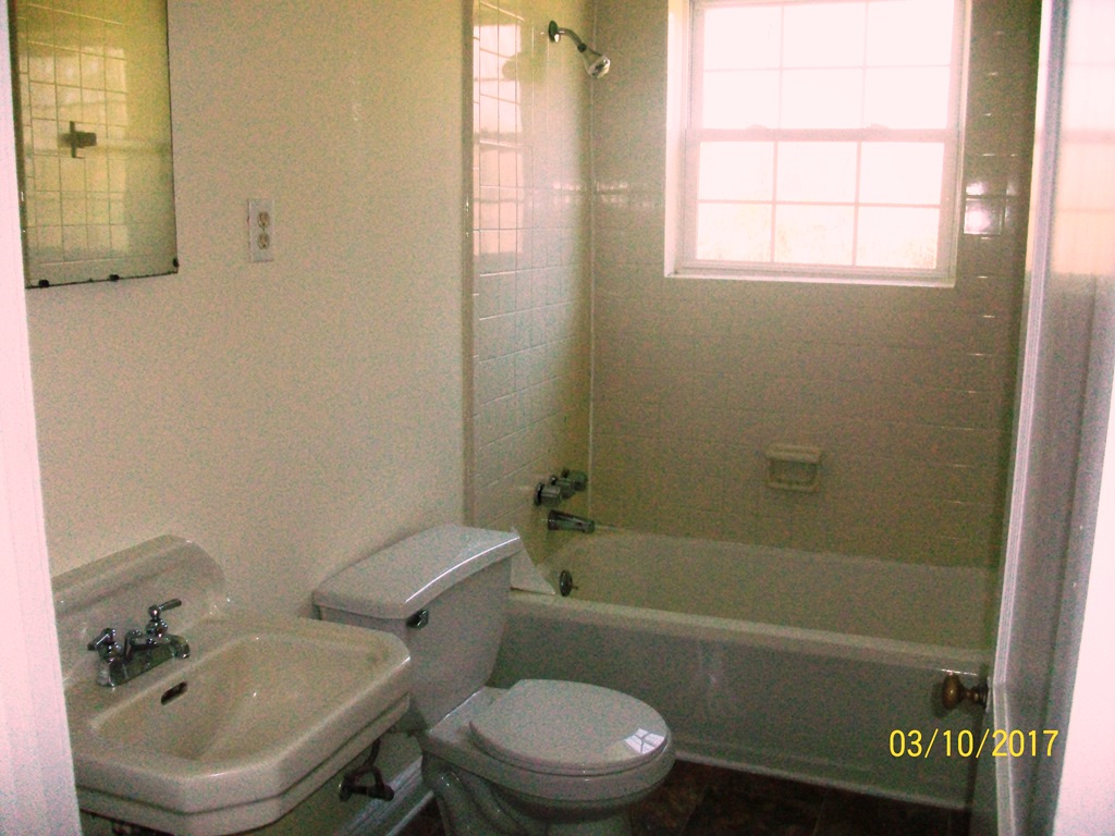 2040 Corinth Drive Seneca, SC 29672 - Photo 2 of 10 This bathroom features a classic tub and shower combination with a bright window.