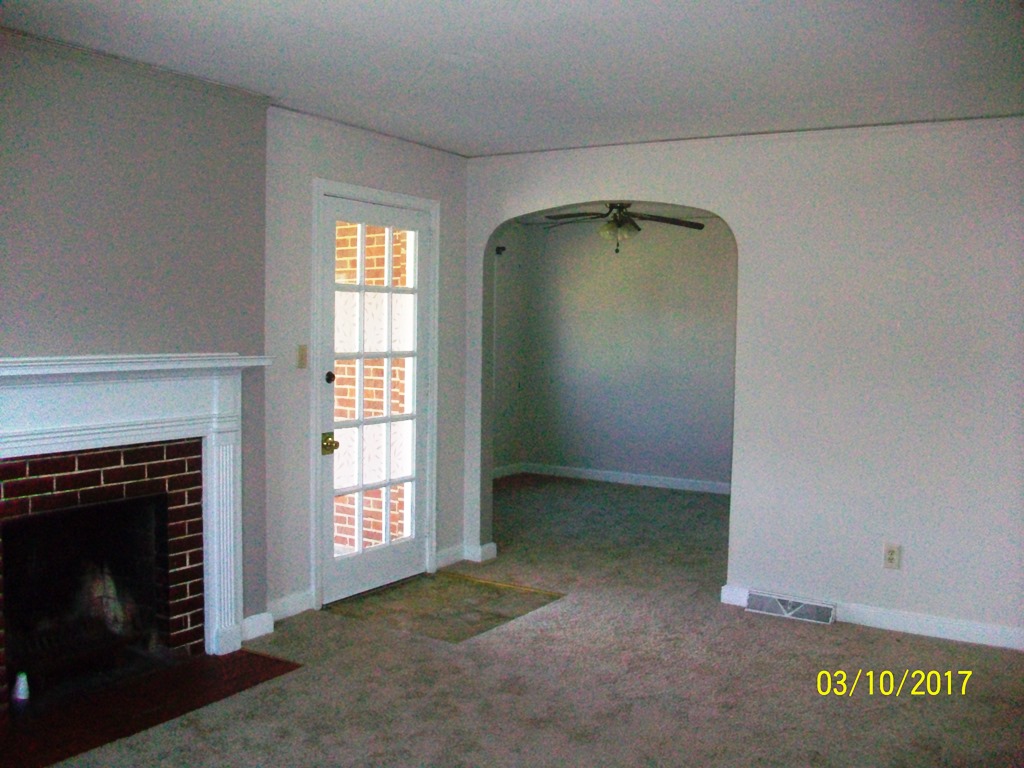 2040 Corinth Drive Seneca, SC 29672 - Photo 9 of 10 This inviting living area features a brick fireplace and a unique arched entryway.