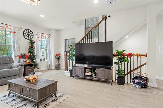 a living room with furniture and a chandelier