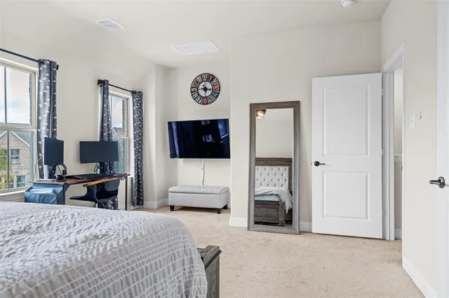 a bedroom with a bed and a television