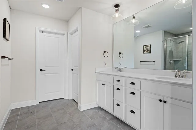 a bathroom with a granite countertop sink mirror and double