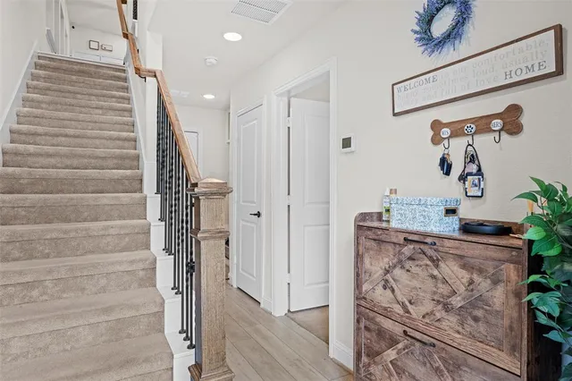 a kitchen with stainless steel appliances white cabinets and a hard wood floor