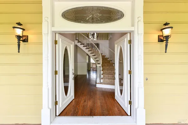 a view of a hallway with wooden floor
