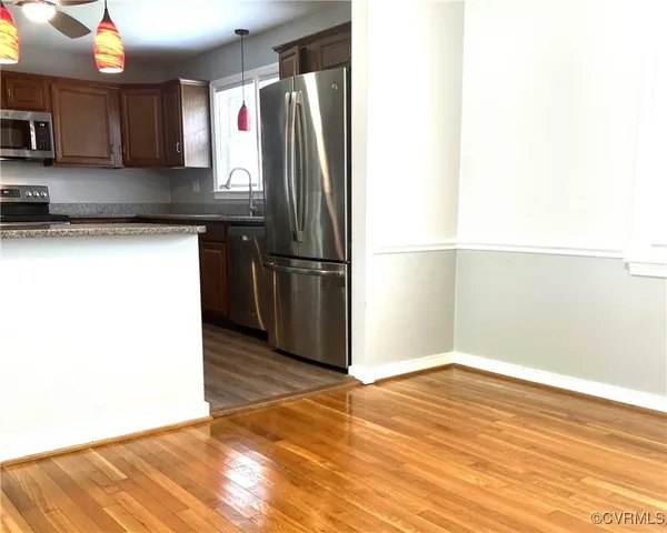 a kitchen with stainless steel appliances granite countertop a refrigerator and a sink