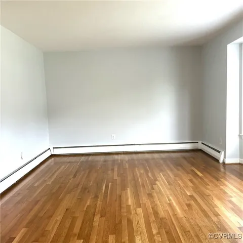 a view of an empty room and wooden floor