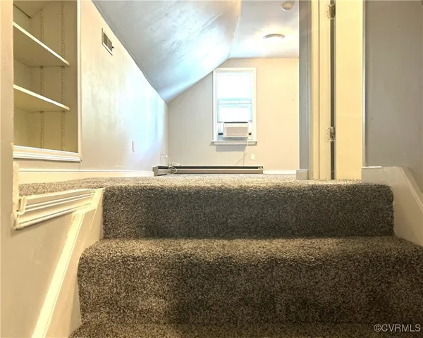 a bathroom with a bathtub and a window