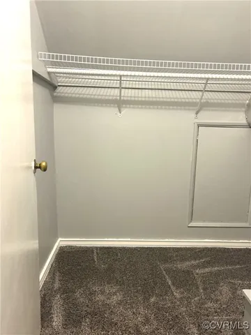 a view of a closet with wooden floor