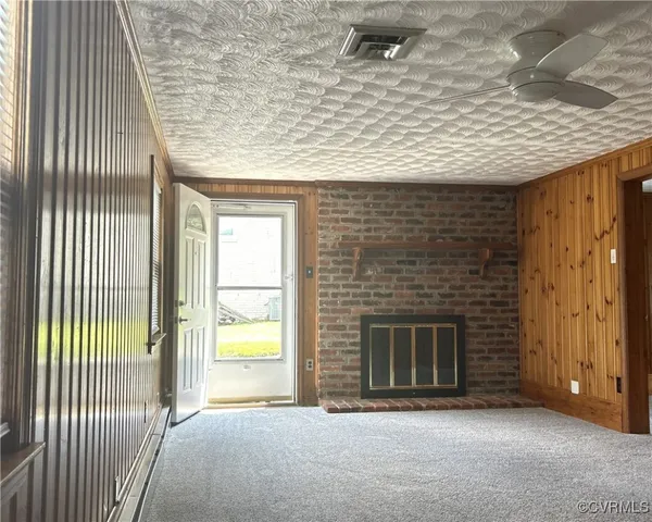 a view of an empty room with a fireplace