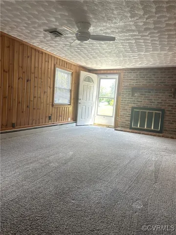 a view of an empty room with a fireplace