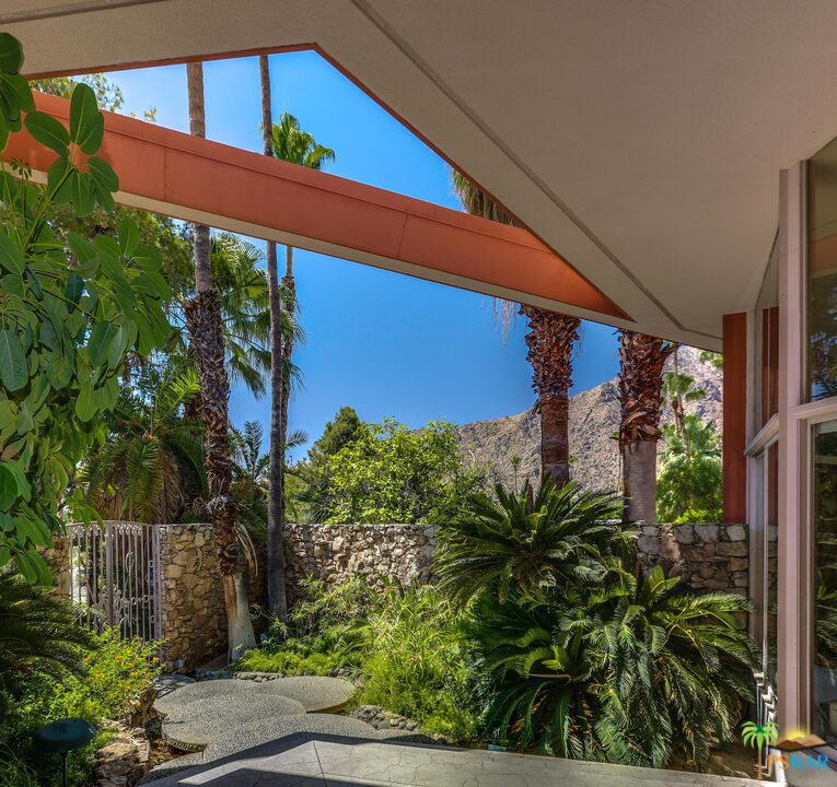 1350 Ladera Circle Palm Springs, CA 92262 - Photo 11 of 50 a view of a house with a small yard plants and large tree