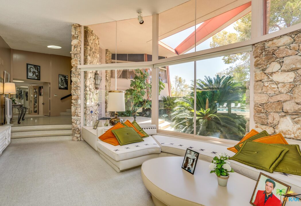 1350 Ladera Circle Palm Springs, CA 92262 - Photo 17 of 50 a living room with patio furniture and a floor to ceiling window
