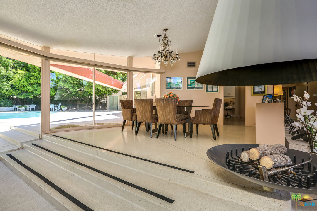 1350 Ladera Circle Palm Springs, CA 92262 - Photo 22 of 50 a dining room with furniture a floor to ceiling window and a table