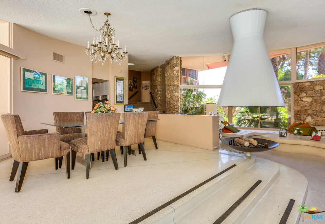 1350 Ladera Circle Palm Springs, CA 92262 - Photo 24 of 50 a view of a dining room with furniture and a chandelier