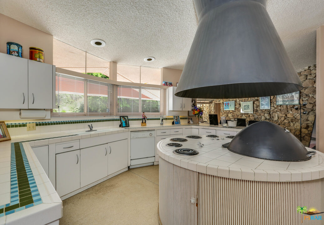 1350 Ladera Circle Palm Springs, CA 92262 - Photo 29 of 50 a kitchen with stainless steel appliances a sink a stove and a refrigerator