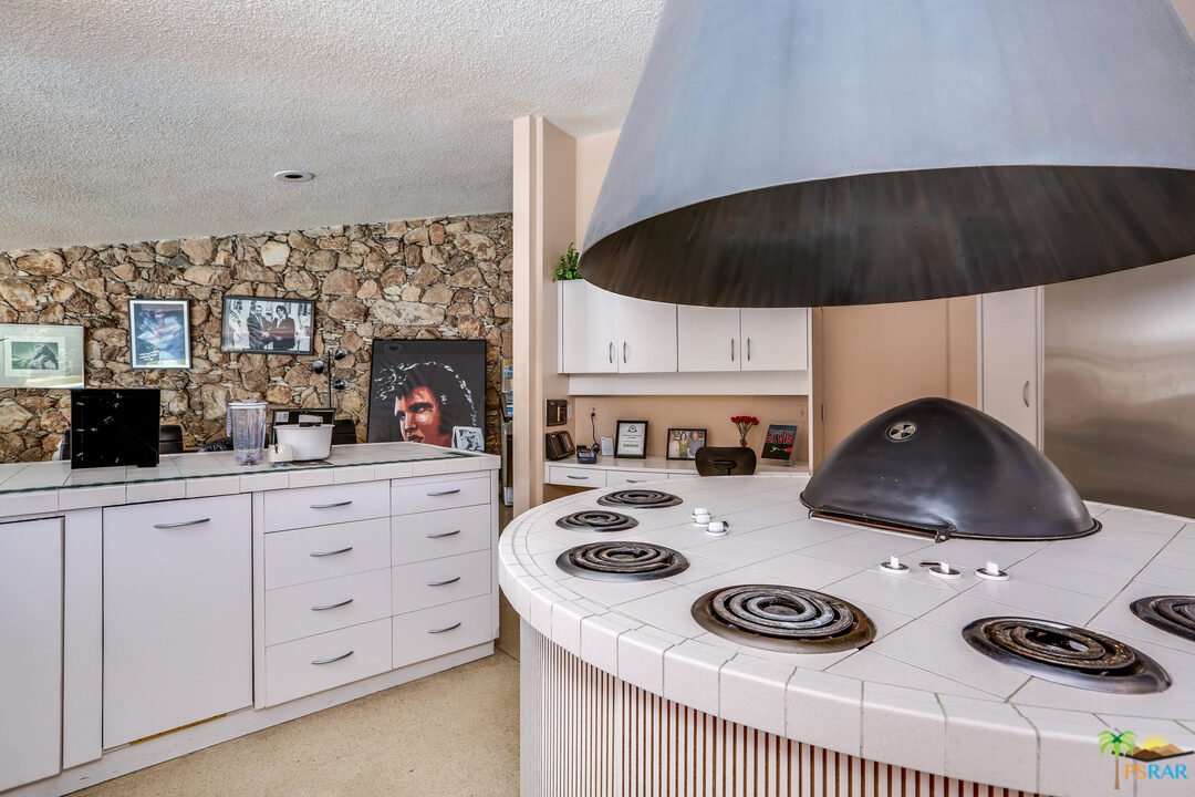 1350 Ladera Circle Palm Springs, CA 92262 - Photo 30 of 50 a kitchen with a stove a refrigerator and cabinets
