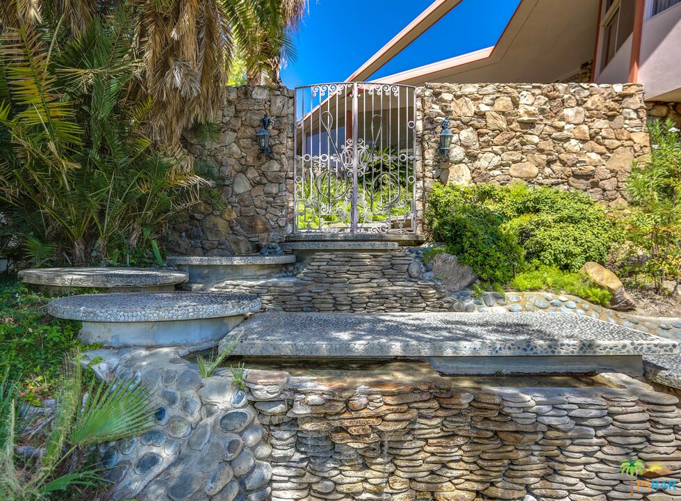 1350 Ladera Circle Palm Springs, CA 92262 - Photo 9 of 50 a view of a water fountain with large trees
