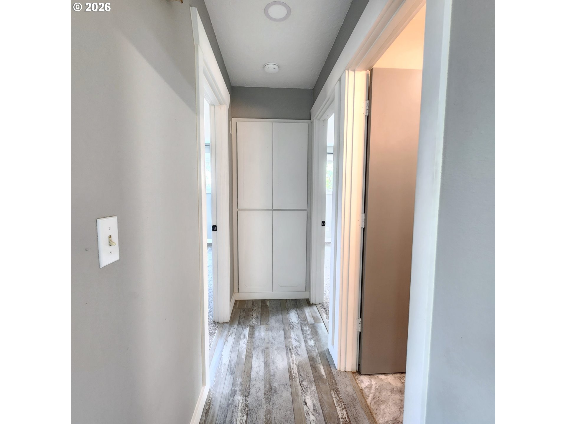 54047 West Lane Road Scappoose, OR 97056 - Photo 7 of 44 a view of a hallway with wooden floor and a bathroom