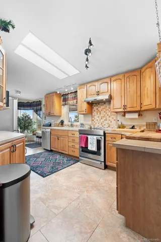 a view of a patio with table and chairs with wooden floor and fence