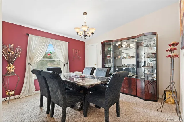 a living room with furniture a piano and a bookshelf