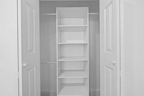 a view of walk in closet with empty racks