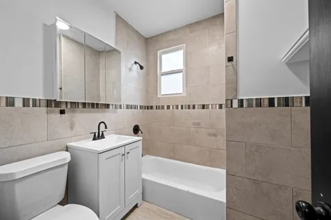 a bathroom with a sink a toilet and bathtub
