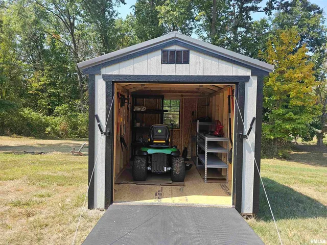 a view of a house with backyard porch and furniture