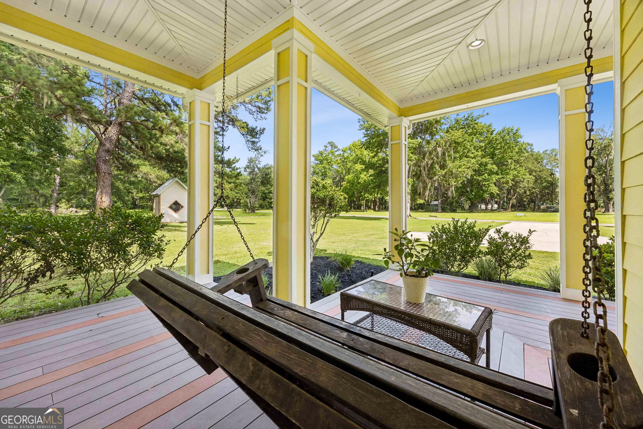 706 Hopewell Point Road White Oak, GA 31568 - Photo 65 of 84 Relax on the porch swing while taking in views of the sprawling front lawn, mature trees, and peaceful natural surroundings.