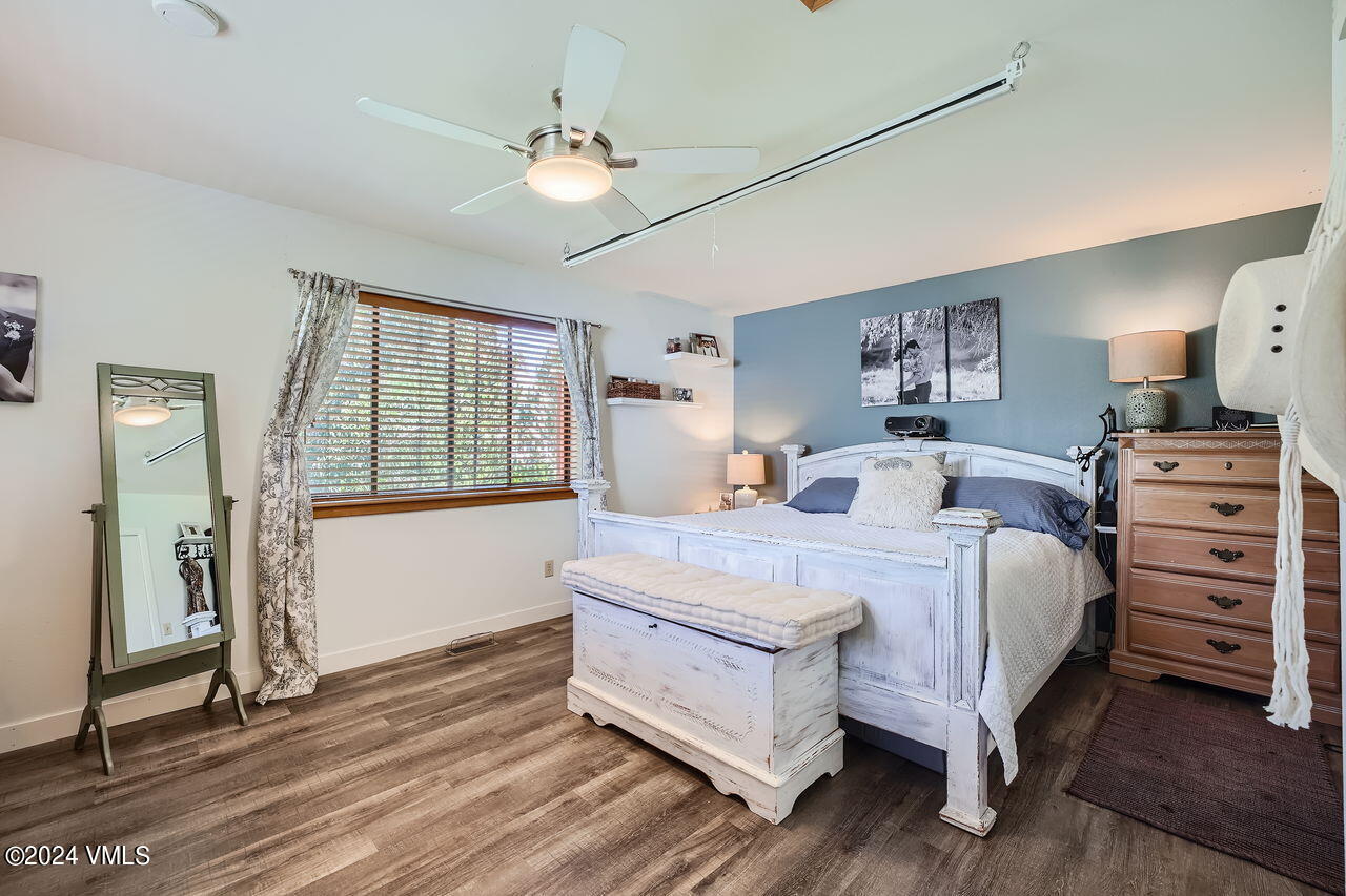 316 Golden Eagle Eagle, CO 81631 - Photo 15 of 25 a bedroom with a bed and a chandelier