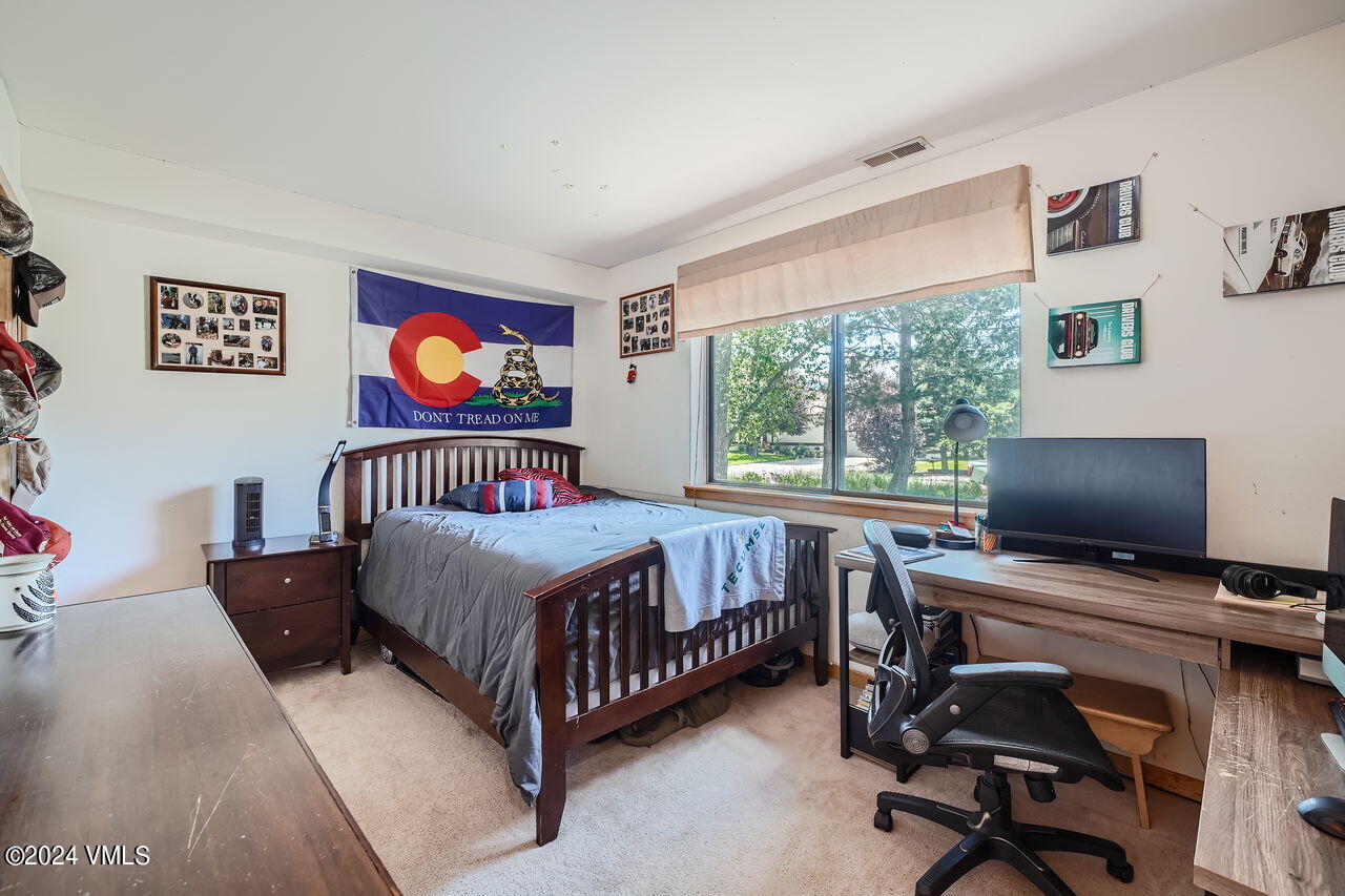 316 Golden Eagle Eagle, CO 81631 - Photo 19 of 25 a bedroom with a bed and a desk