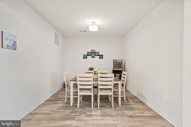 a dining room with furniture and wooden floor