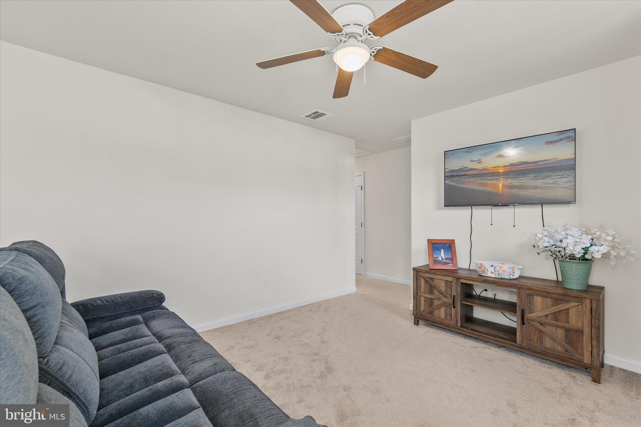 33204 Cross Road Frankford, DE 19945 - Photo 17 of 35 a living room with furniture and a flat screen tv