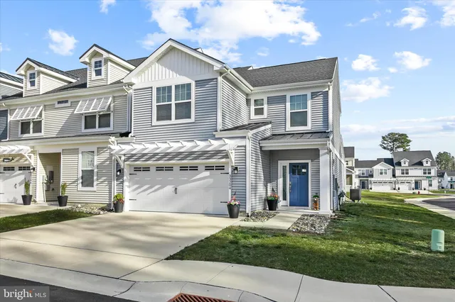 a front view of a house with a garden and yard