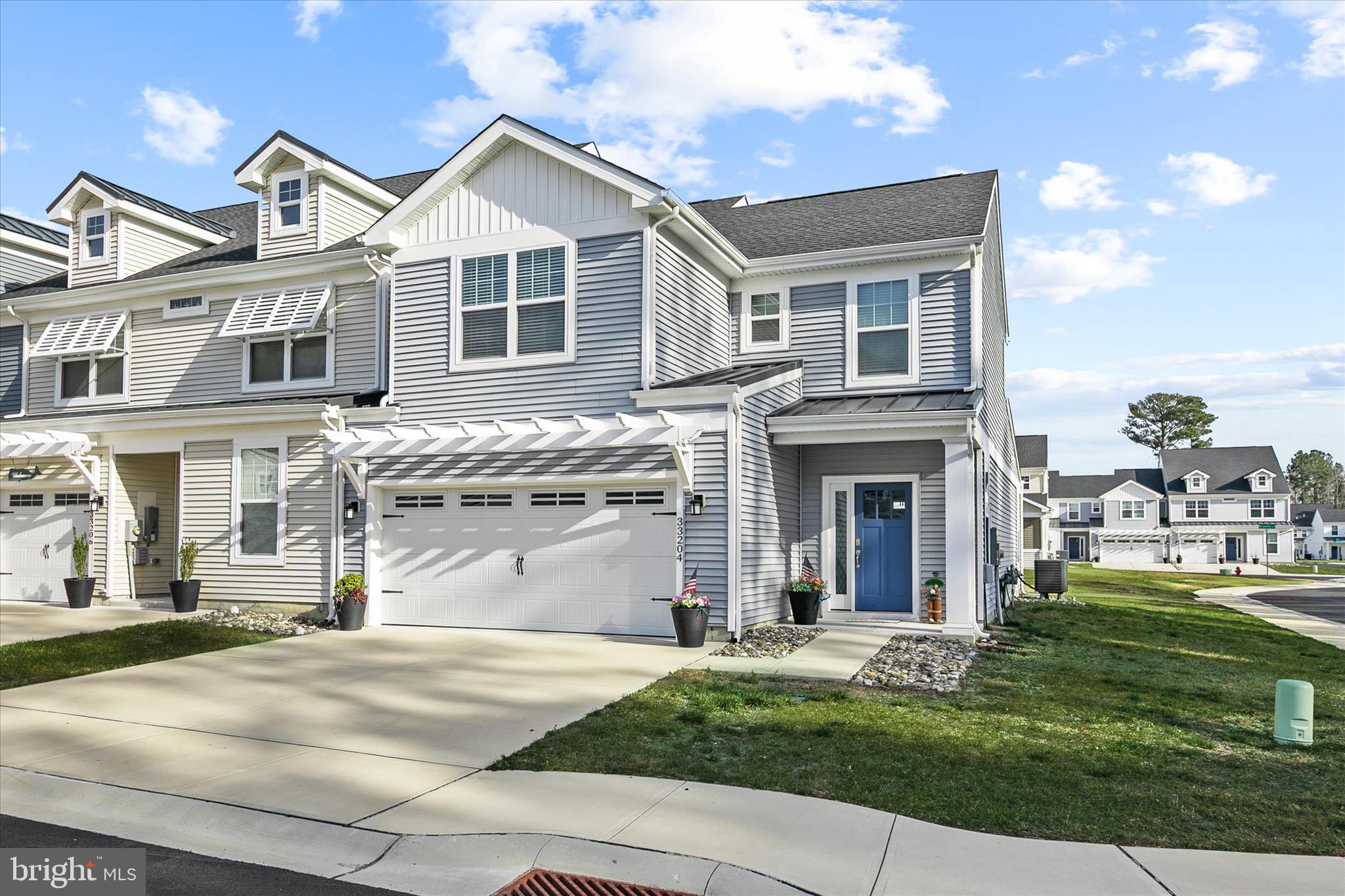 33204 Cross Road Frankford, DE 19945 - Photo 3 of 35 a front view of a house with a garden and yard