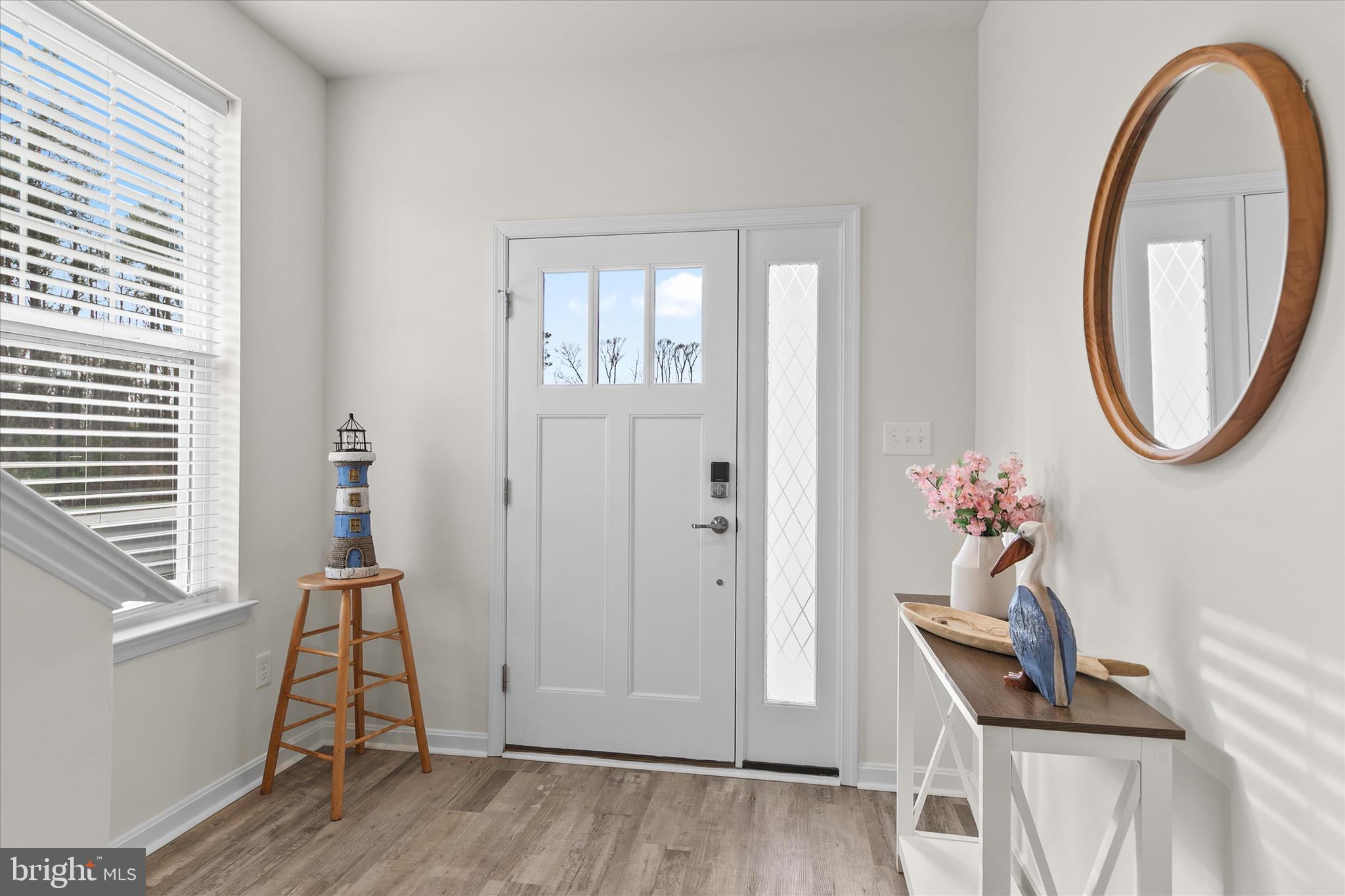 33204 Cross Road Frankford, DE 19945 - Photo 4 of 35 a view of a room with wooden floor and a potted plant