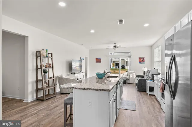 a living room with fireplace furniture and a wooden floor