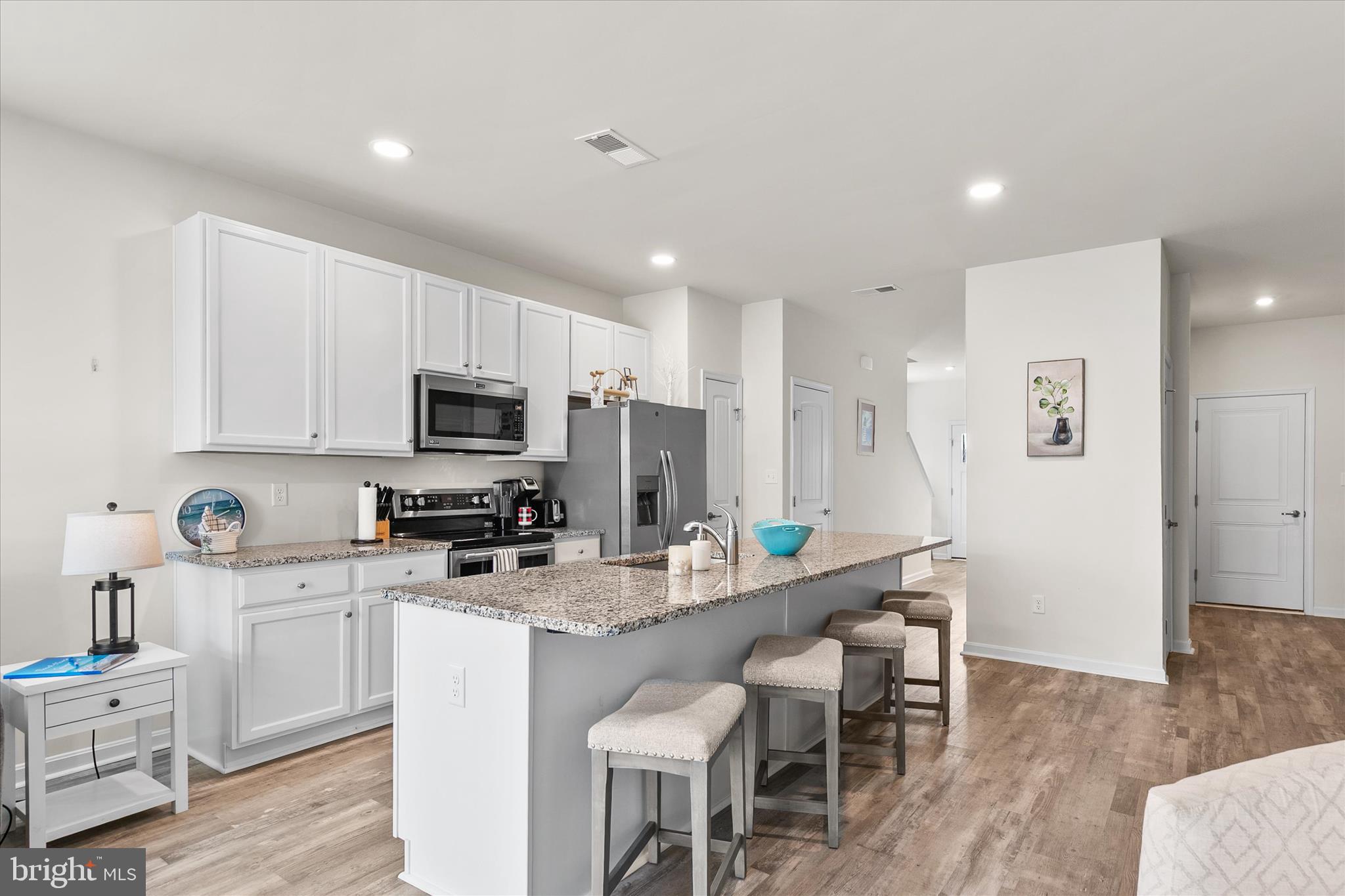 33204 Cross Road Frankford, DE 19945 - Photo 8 of 35 a kitchen with white cabinets and stainless steel appliances