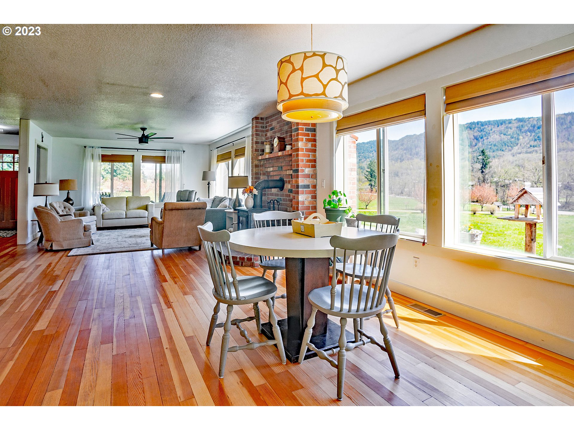 29416 Northeast Healy Road, Unit 2 Amboy, WA 98601 - Photo 19 of 41 a view of a dining room with furniture a chandelier and wooden floor