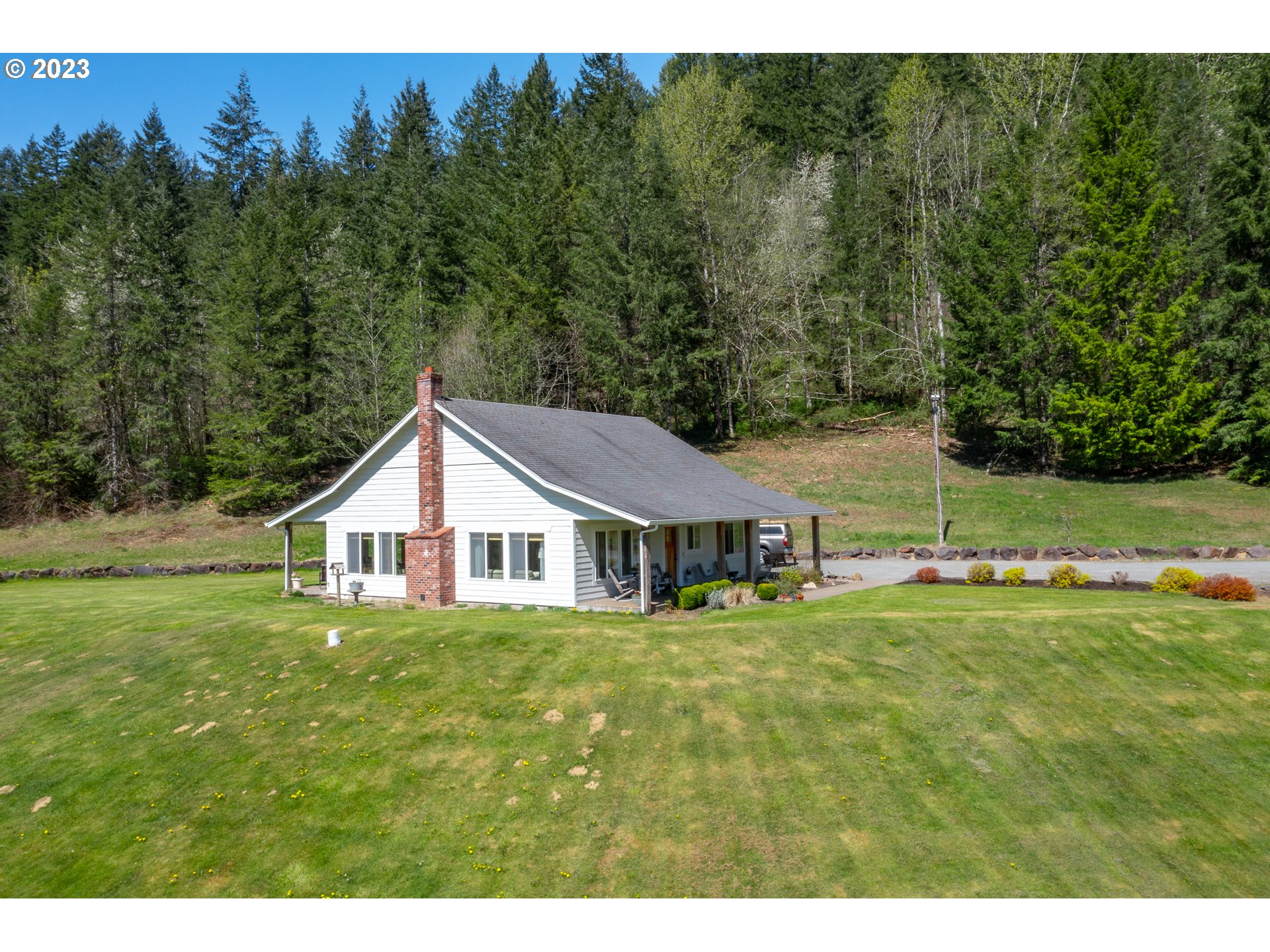 29416 Northeast Healy Road, Unit 2 Amboy, WA 98601 - Photo 3 of 41 a white house with a big yard and large trees