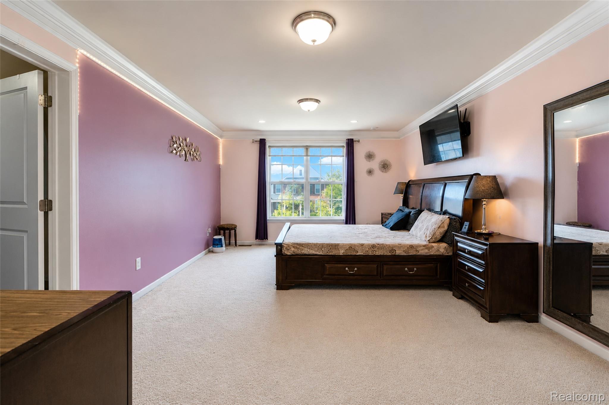 50873 Scarborough Road Canton, MI 48188 - Photo 18 of 33 Spacious room featuring neutral carpeting, a large window with natural light, and crown molding